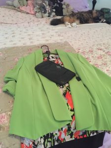 Green jacket, print blouse, black short skirt: Very classy!